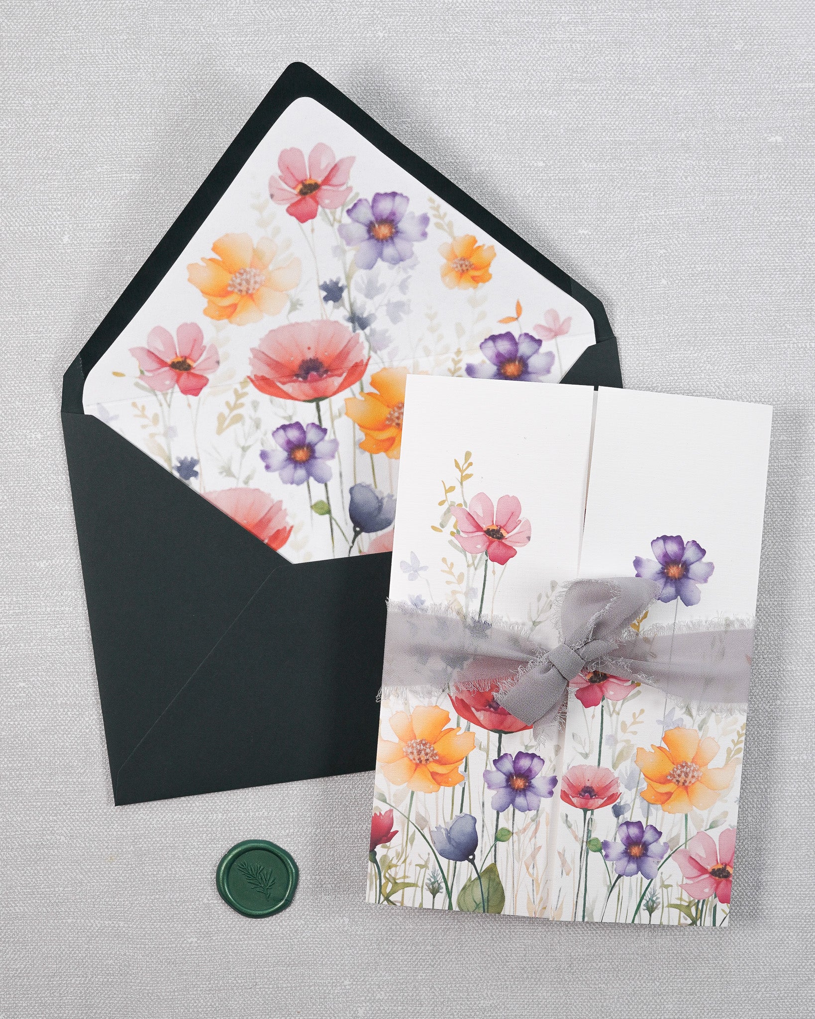Handmade gatefold wedding stationery. With a dark green envelope in a garden print