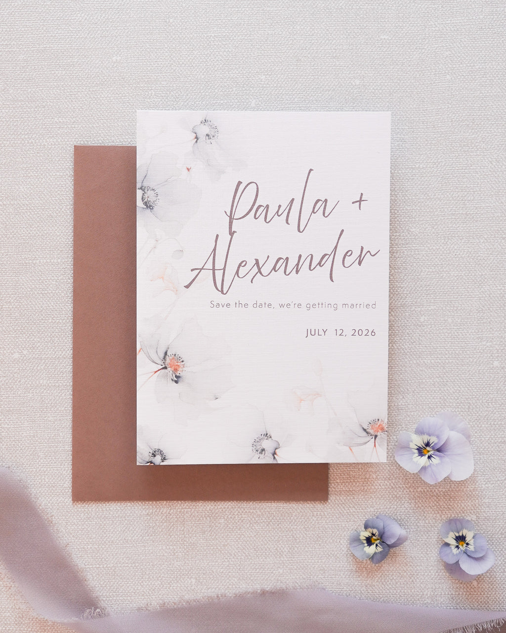 A save the date card in a grey floral print. Matched with a grey envelope