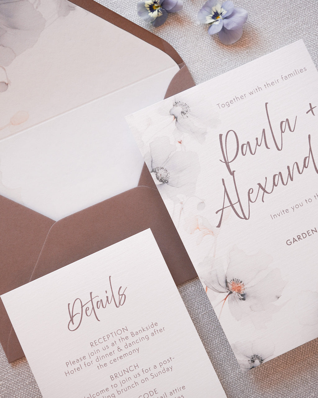 A modern wedding invitation suite with hand painted grey florals.