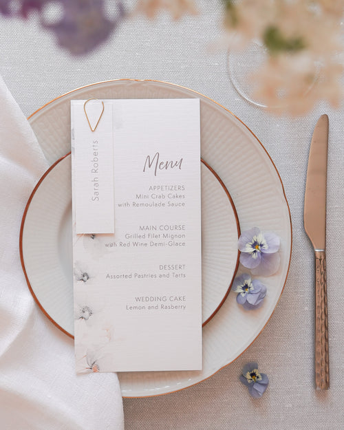 A modern wedding menu card in white with a muted grey floral print.