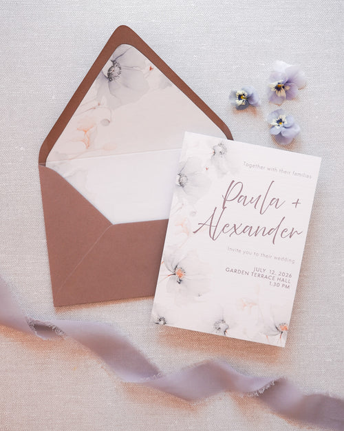A wedding invitation with a soft floral pattern. Combined with a grey envelope with a printed liner. 