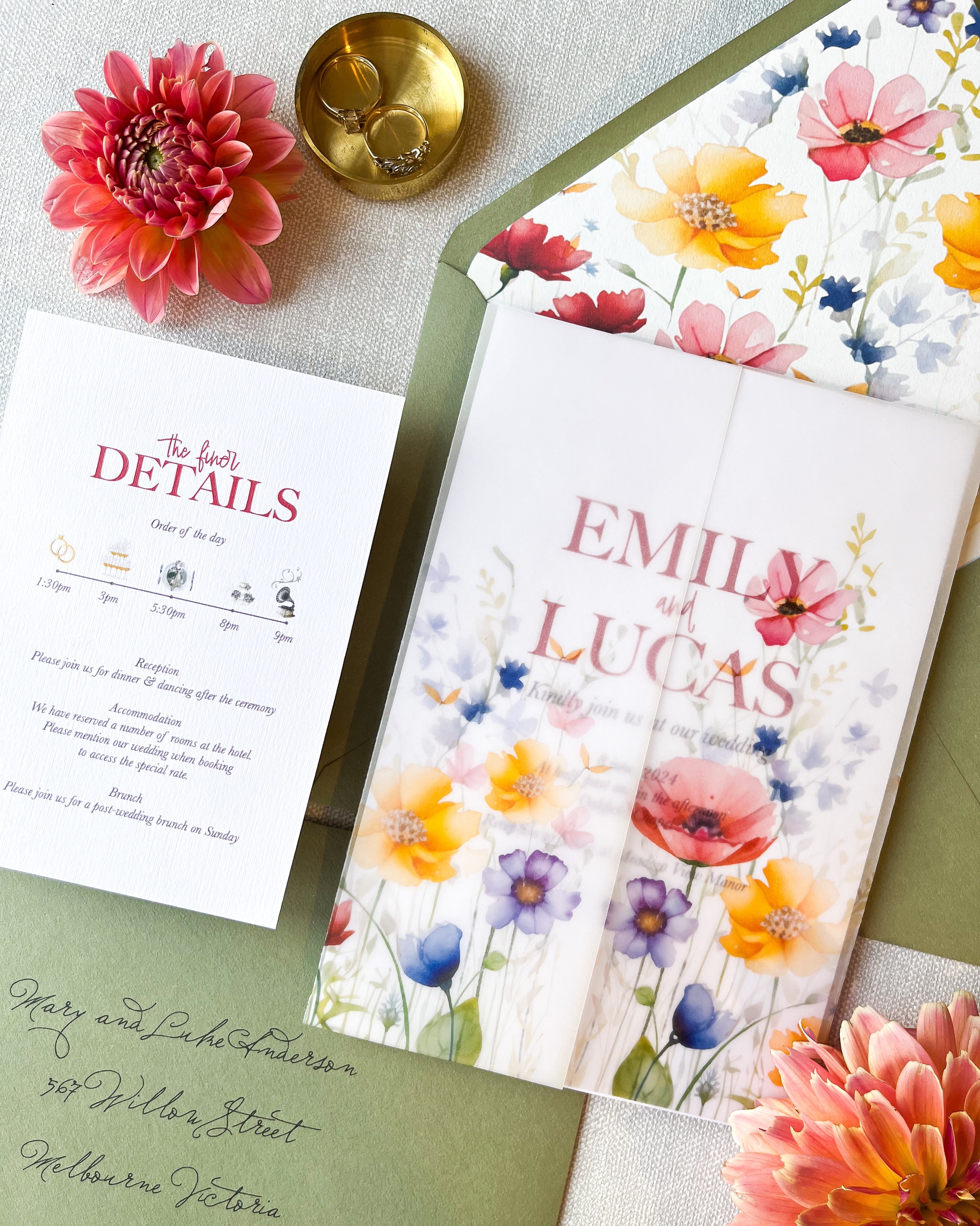 A floral wedding invitation set with a green envelope